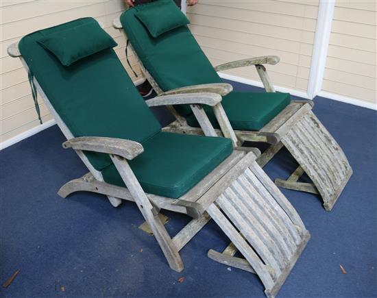 A pair of Indian Ocean teak folding loungers